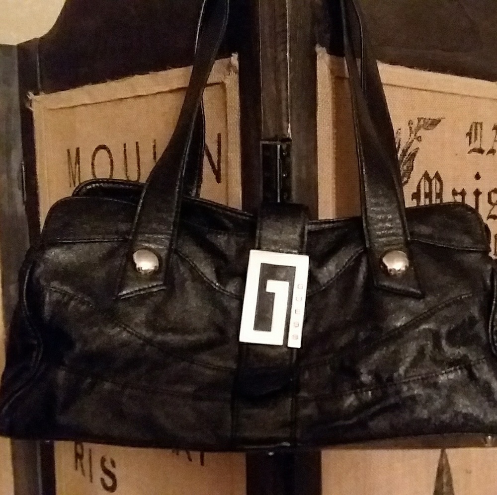 A silk lined black GUESS shoulder bag.